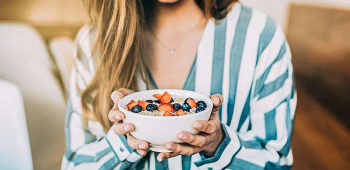 patient eating a healthy cereal after receiving diet guidance from Ontario chiropractor