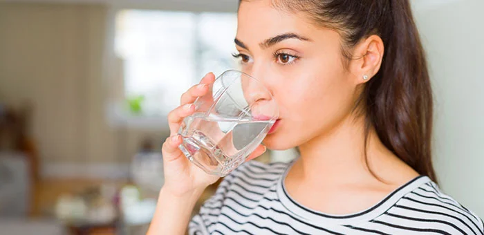 patient drinking water to be healthy under the guidance of Ontario chiropractor