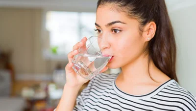 patient drinking water to be healthy under the guidance of Ontario chiropractor